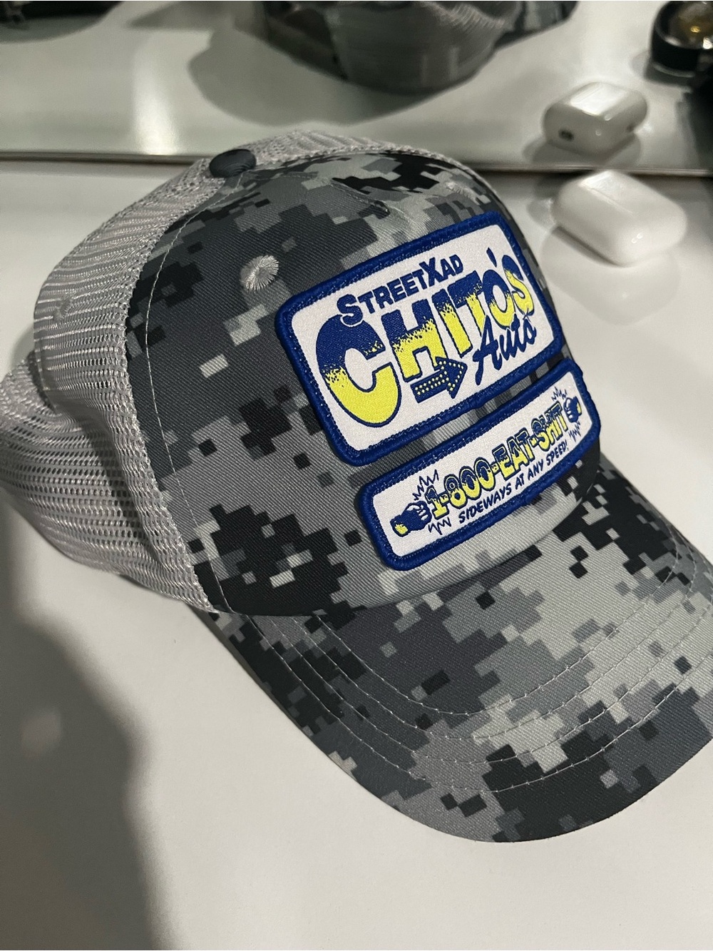 StreetXad Chito Vera ‘Eat Shit’ Grey Camo Trucker Hat